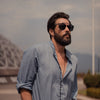 Bearded Male Model wear the Black Breach Sunglasses outside in the sunshine Brass and Unity 